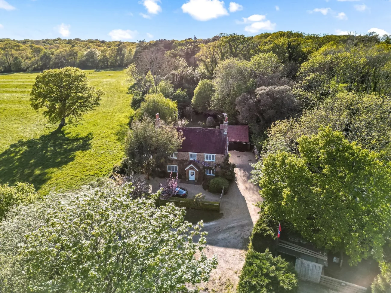Aerial view of cottage, garden and adjacent grazing fields