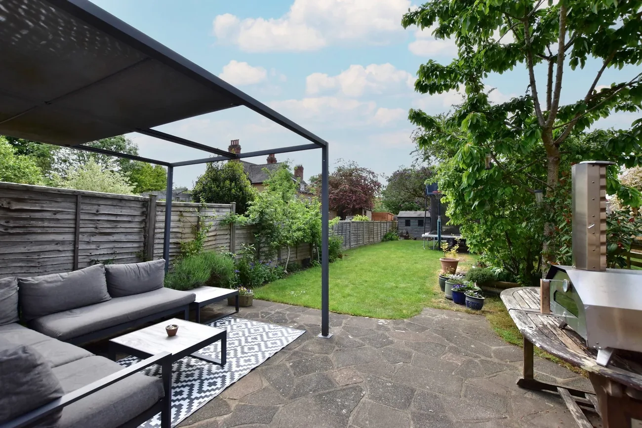 Covered pergola seating area — outdoor living with the garden beyond