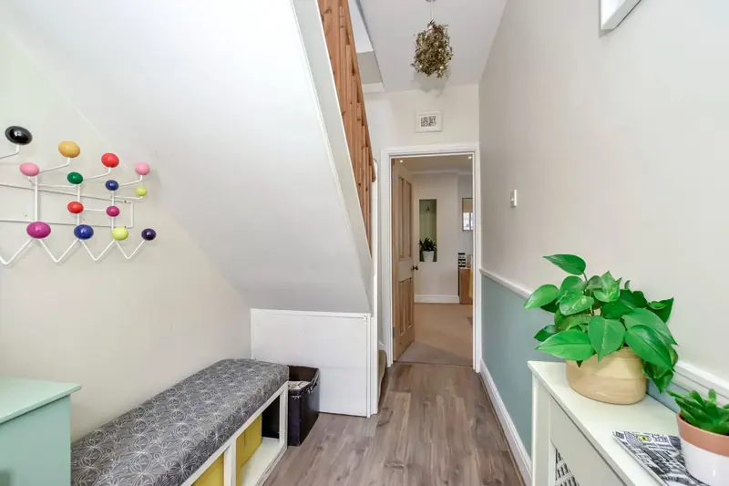 Mudroom — coat hooks and boot storage at the rear hallway