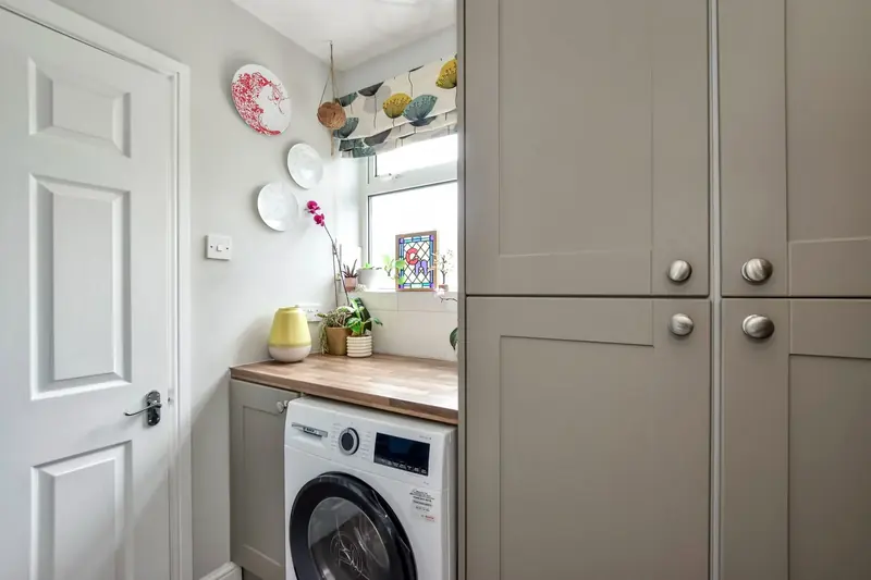 Utility room — washing machine and storage, discreetly apart from the living spaces