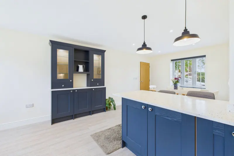 The dresser unit detail with inset lighting, deep navy cabinetry and Minerva worktops