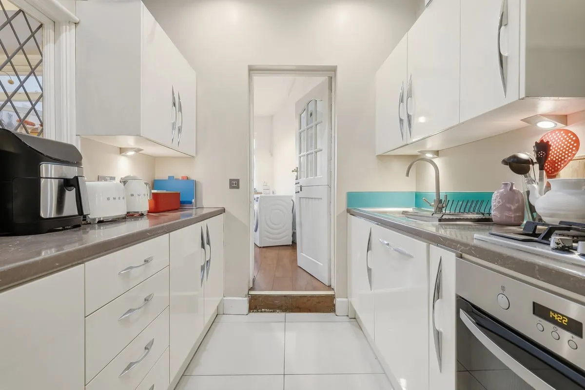 Kitchen — white shaker units and tiled splashback
