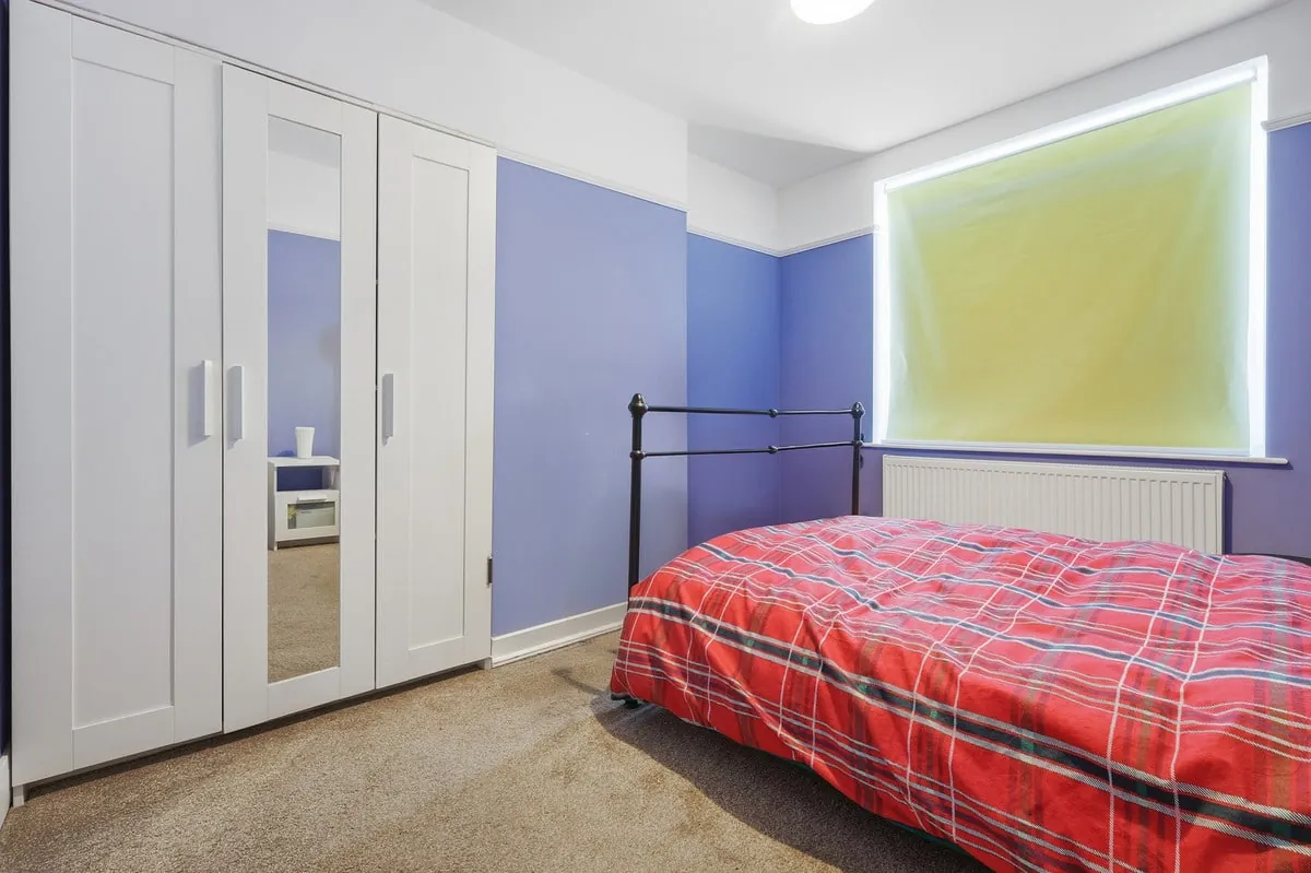 Principal bedroom — fitted wardrobes and accent feature wall