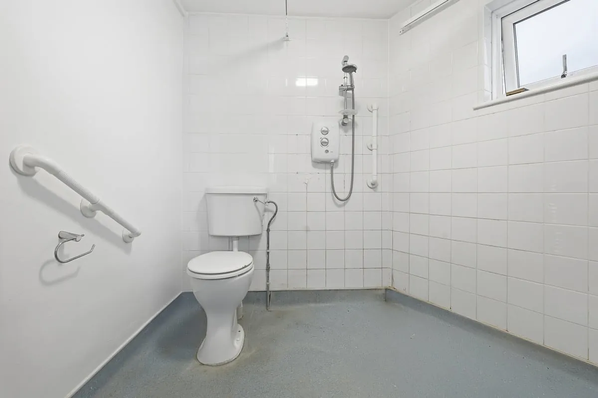 Shower room — walk-in cubicle, wall-hung WC, full-height tiling