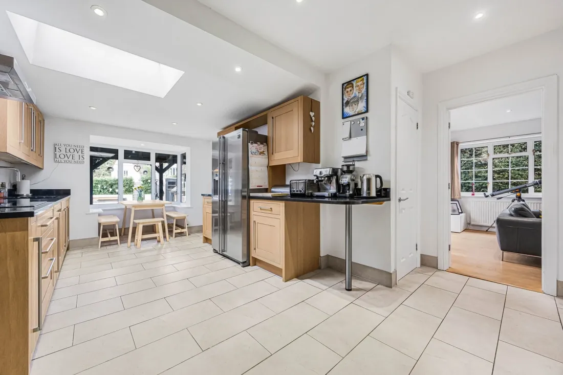 The kitchen at Fernie Cottage with deep blue island cabinetry