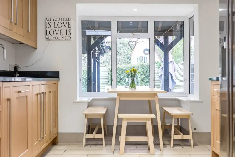 The dining area, opening onto the garden through full-height glazing
