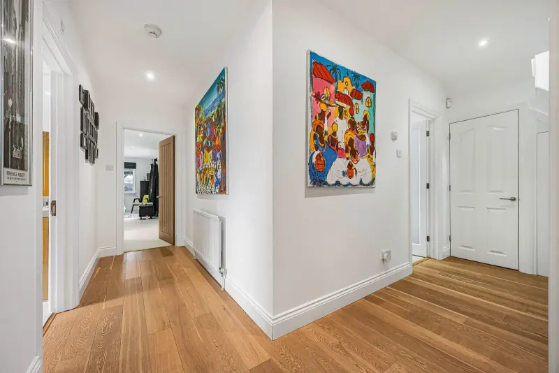 The entrance hallway, warm with natural light and wood floor