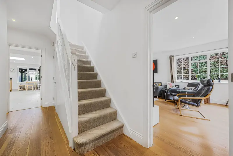 The staircase rising to the upper-floor bedrooms
