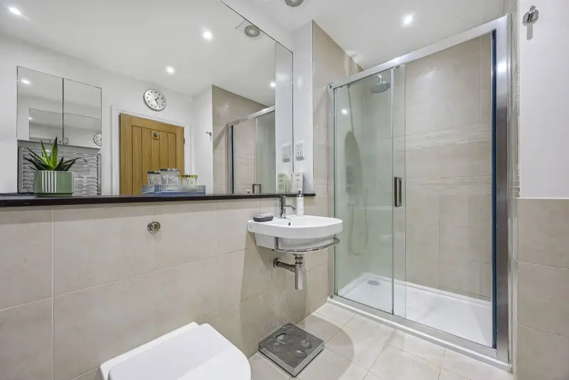 A walk-in shower in stone tile