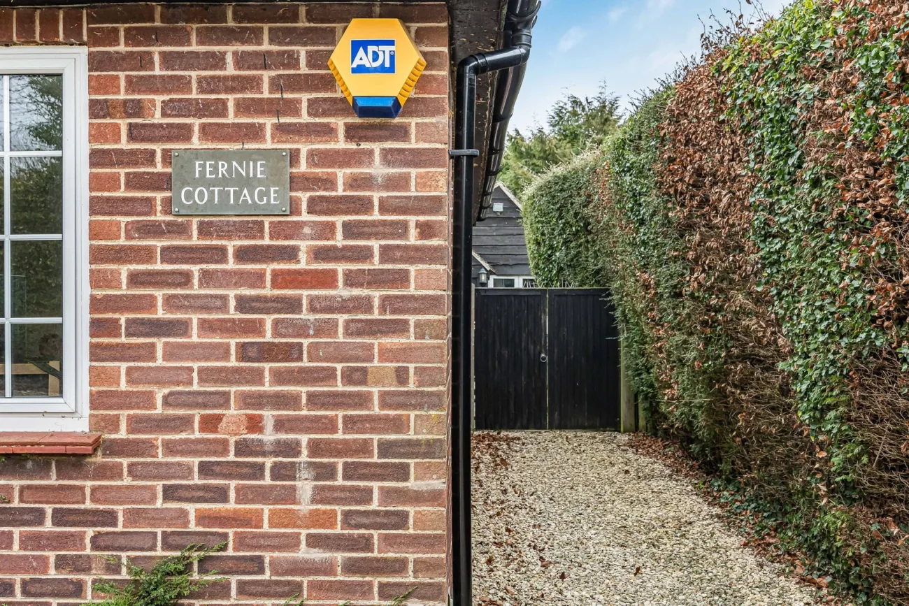 The Fernie Cottage nameplate on warm brick