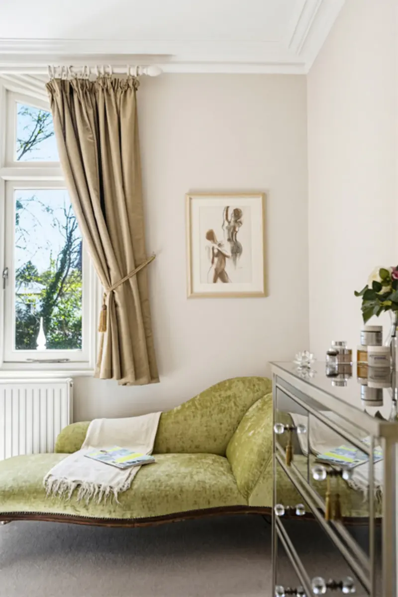 The library reception with shelving and tall sash windows