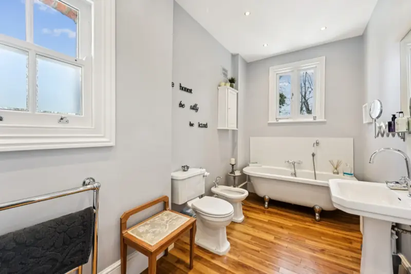 A family bathroom with freestanding bath and panelling