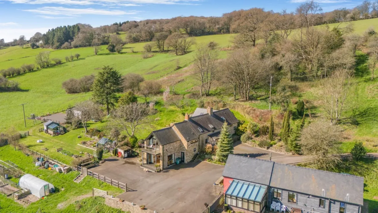 Little Caerlicken — landscape aerial in late afternoon, the house among twelve acres