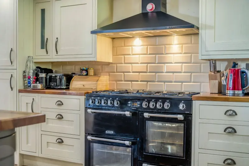 The kitchen with restored cabinetry and range