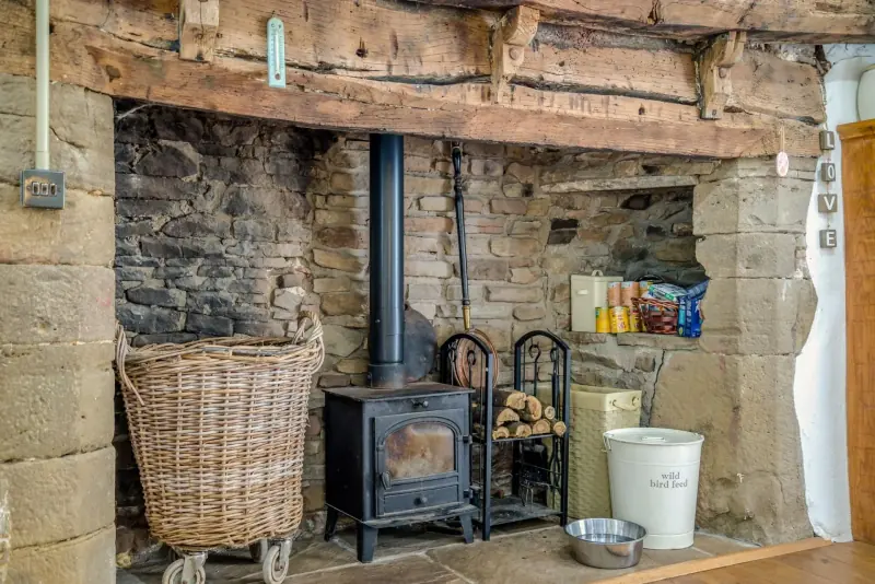 Family-room woodburner against stone wall