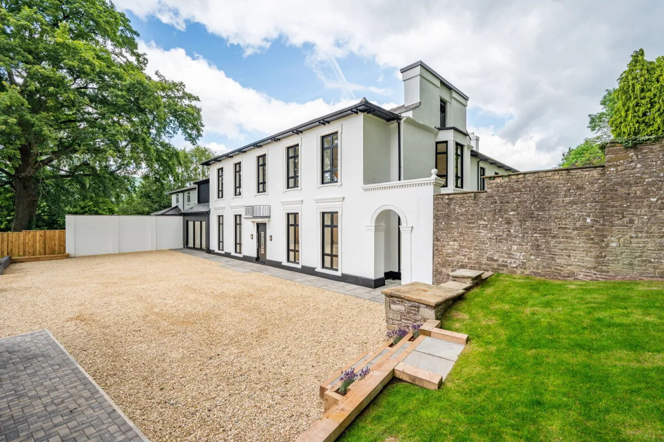 The principal elevation of Lucia Court across its gravel drive