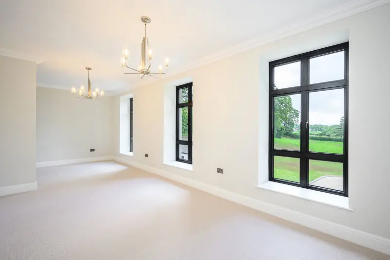 A reception room with a bay overlooking the gardens