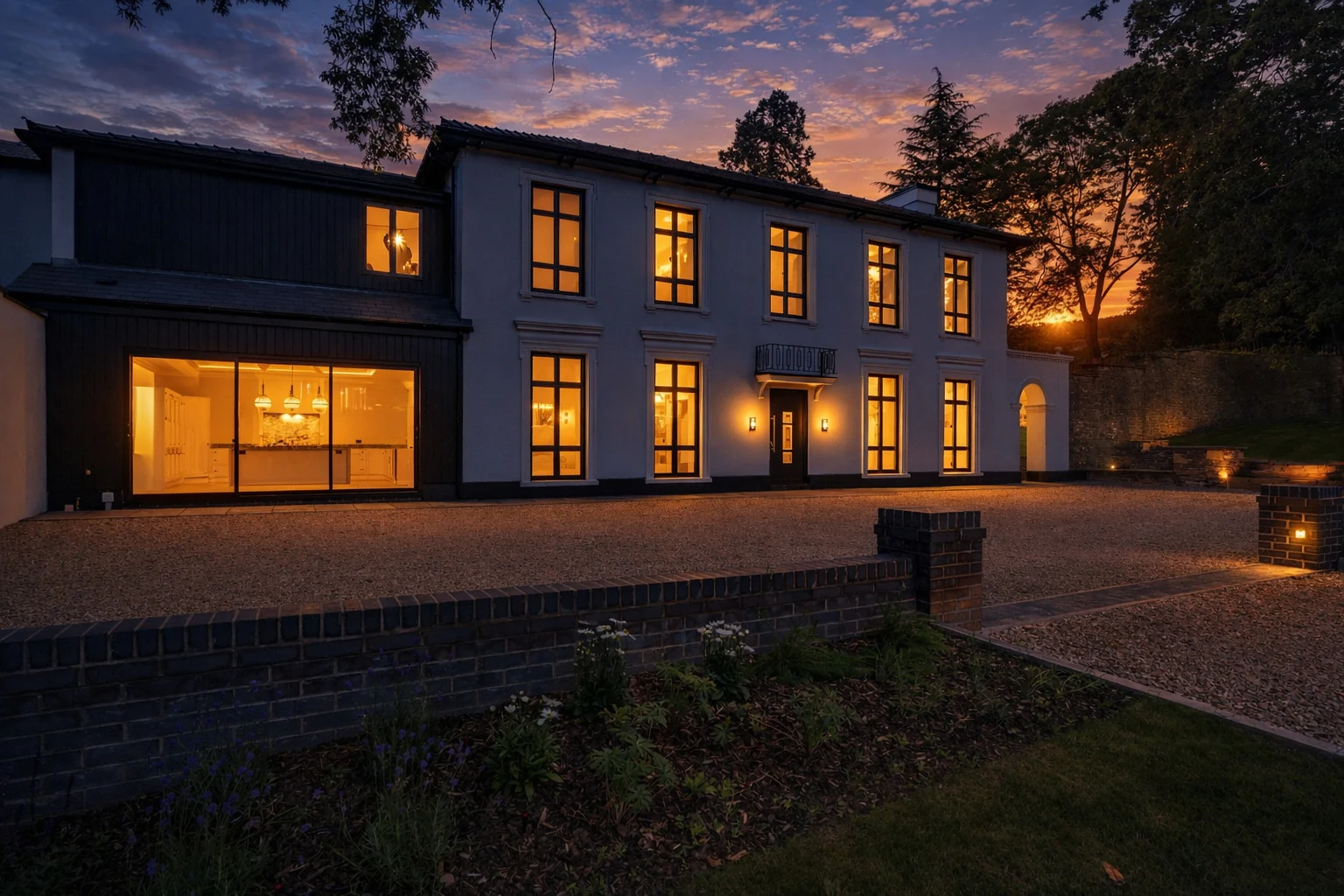 Lucia Court at twilight, the windows lit against a Monmouthshire sunset
