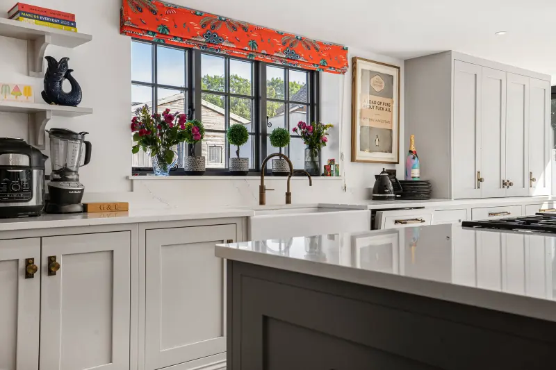 The kitchen with red blinds and dining table