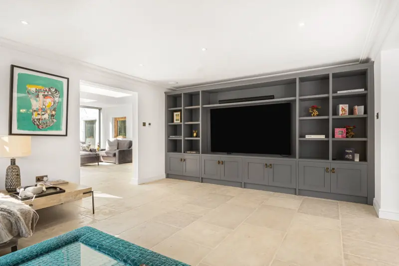 The day room with recessed television and bespoke shelving