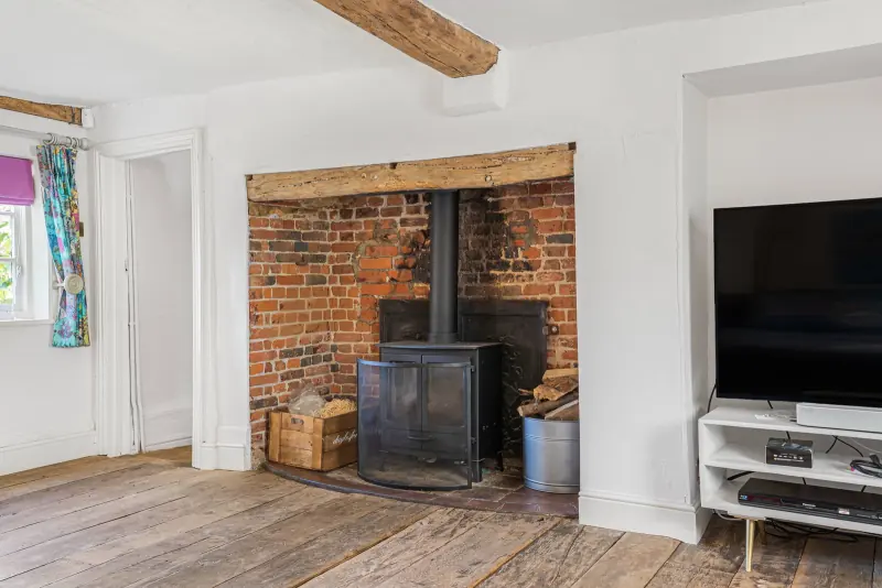 The inglenook fireplace with log burner and exposed brick