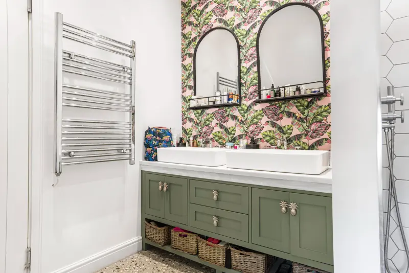 The family bathroom with copper-hex tile and green vanity