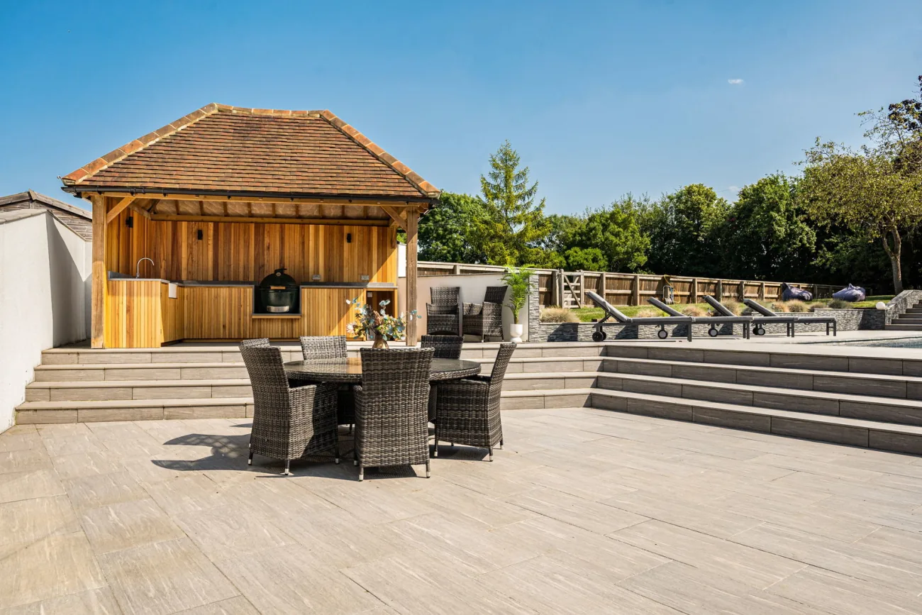 The cedar-clad outdoor kitchen with bench seating