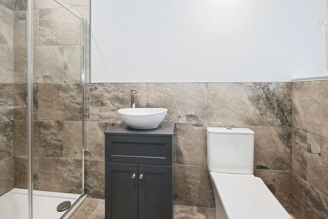 Principal en-suite with walk-in rainfall shower.