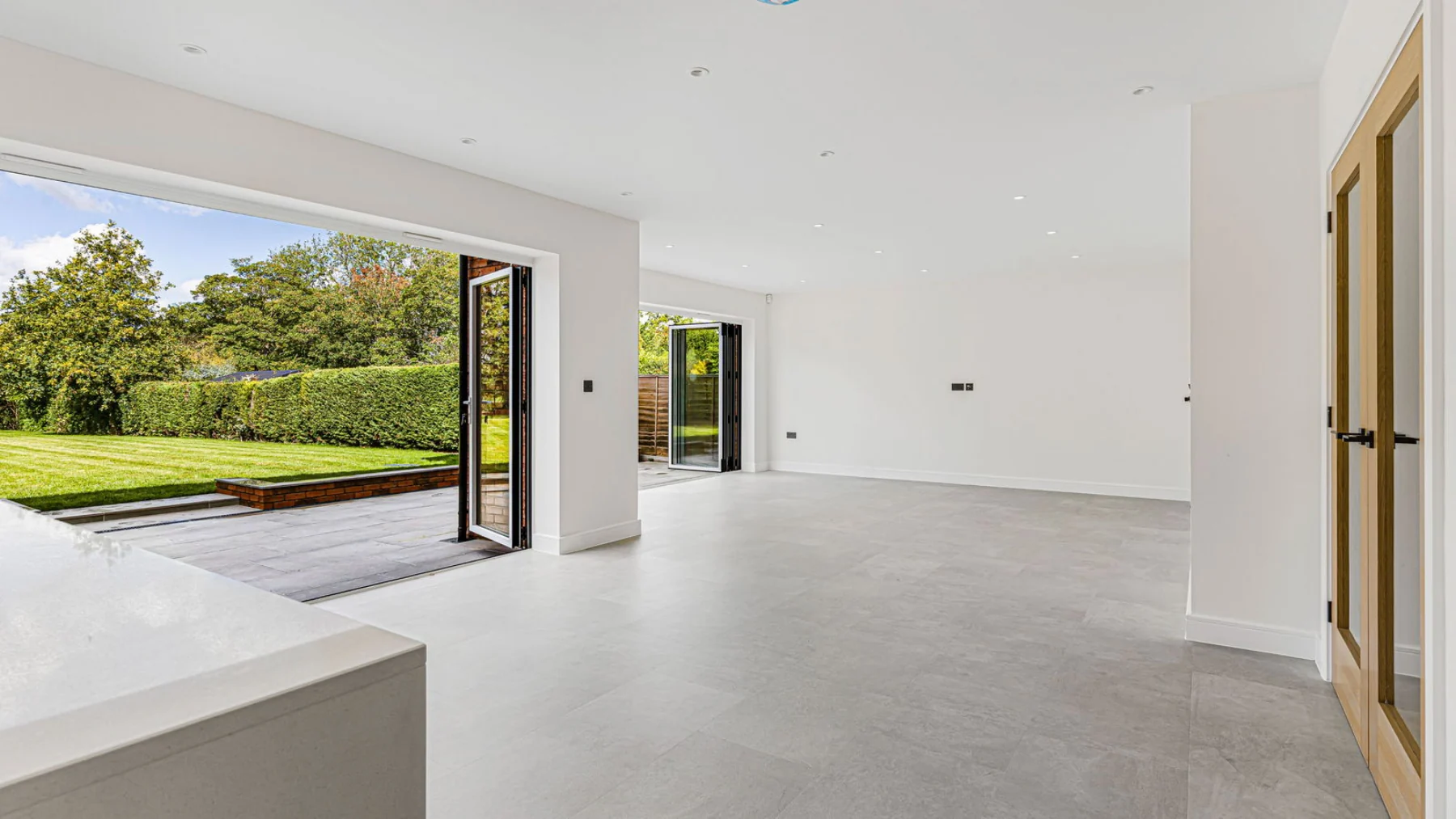 The landscaped garden and patio with field views beyond.