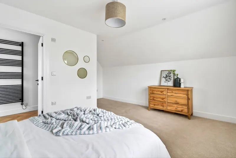 The principal bedroom — vaulted under the dormer