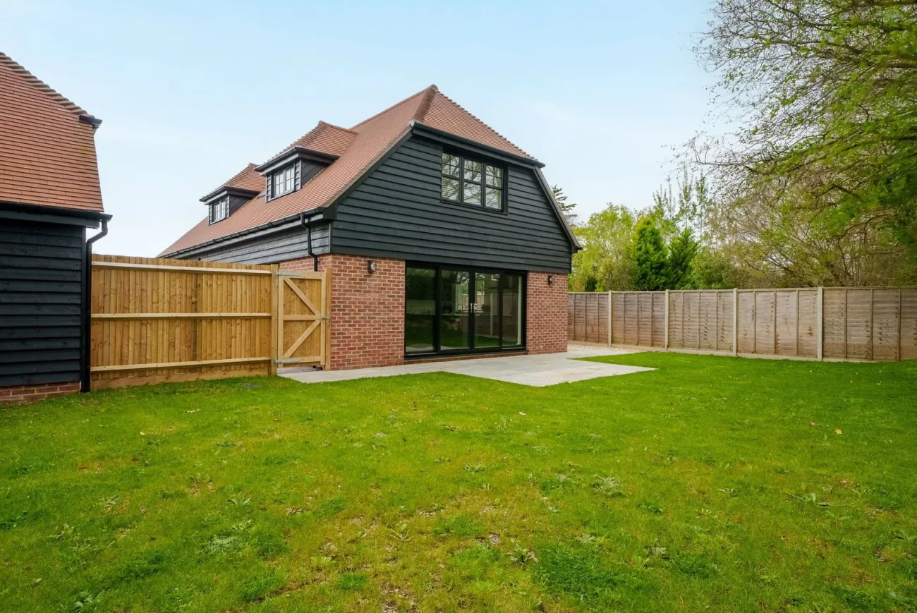 The rear of the home, dark cladding above brick