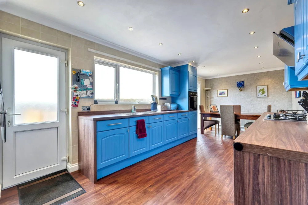 The cobalt blue kitchen-diner with French doors to the deck
