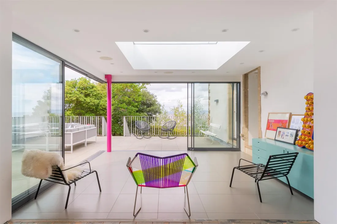 The glass-walled coastal pavilion opening to the rear terrace.