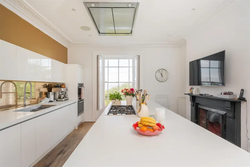 The working Shaker kitchen with original cast-iron fireplace.