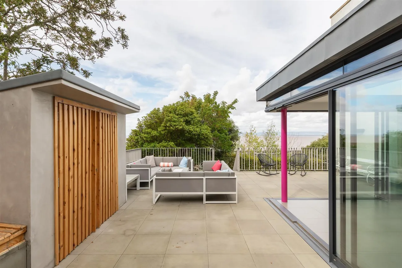 The rear terrace, outdoor kitchen and pool above the sea.