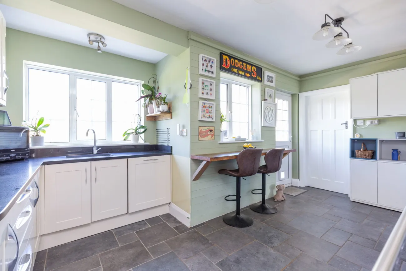 Kitchen sink and breakfast bar, looking through to the secondary garden door.