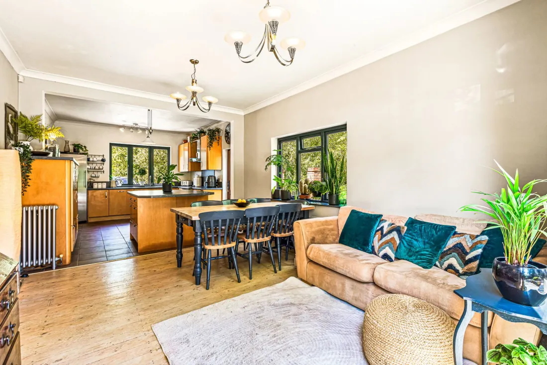 The open kitchen-dining-living room — the home's social spine