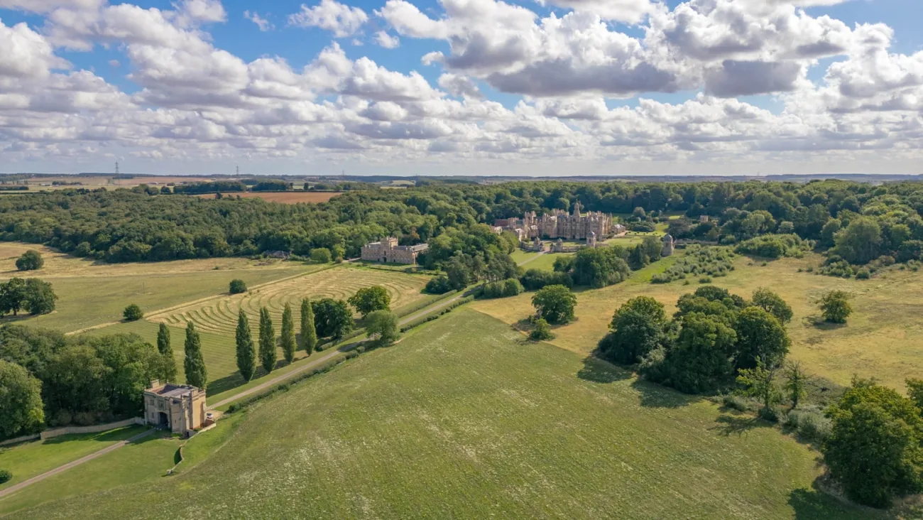 Aerial view of the home in its village-edge setting.