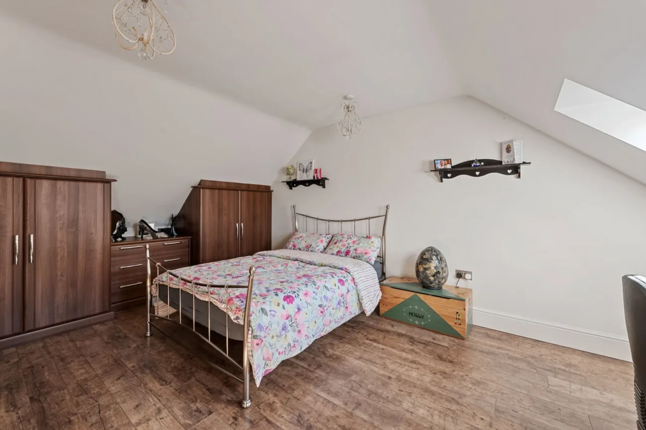 Second-floor bedroom under Velux roof lights.